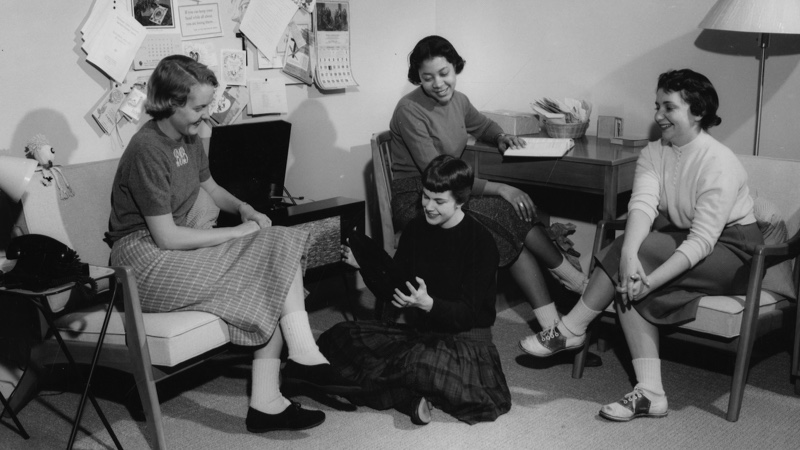 Students in a Dorm Room ( 1958). Four women gather around a record player in their dorm room.