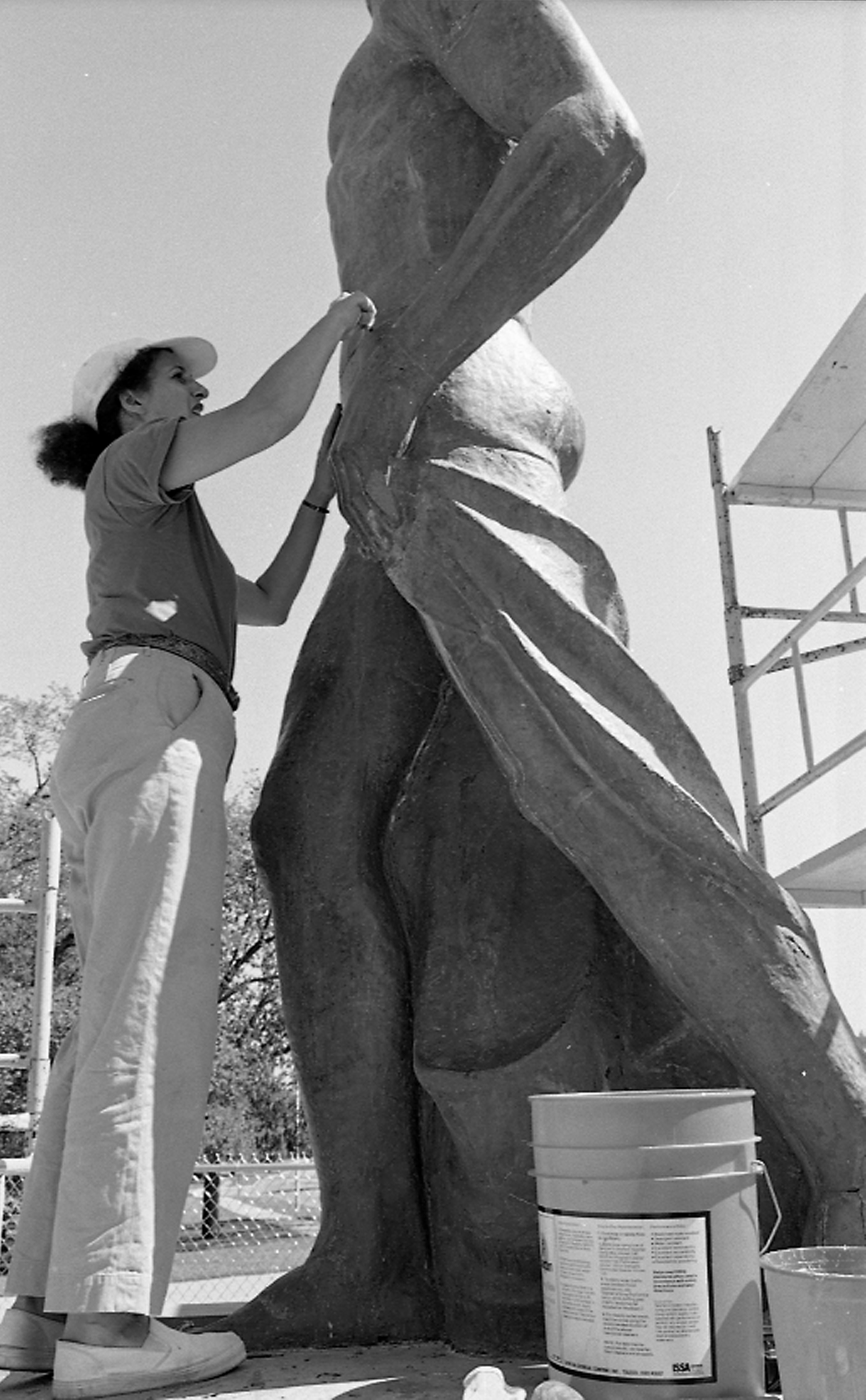 Woman helps to repair Sparty, 1988