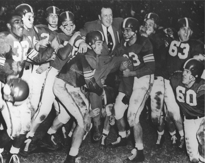 Players lift Coach Munn at the Rose Bowl, 1954