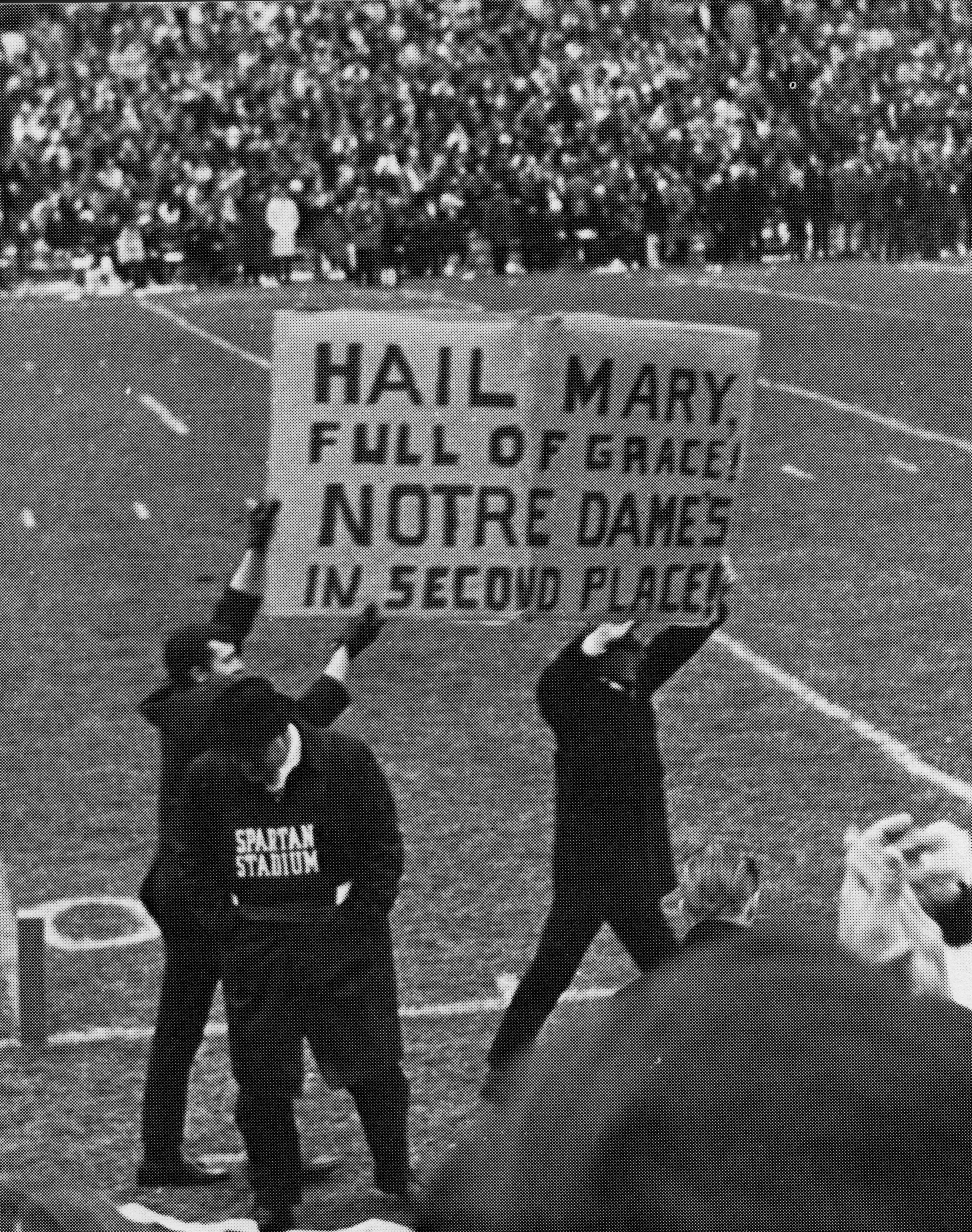 Fans holding a sign at the MSU-Notre Dame football game, 1966
