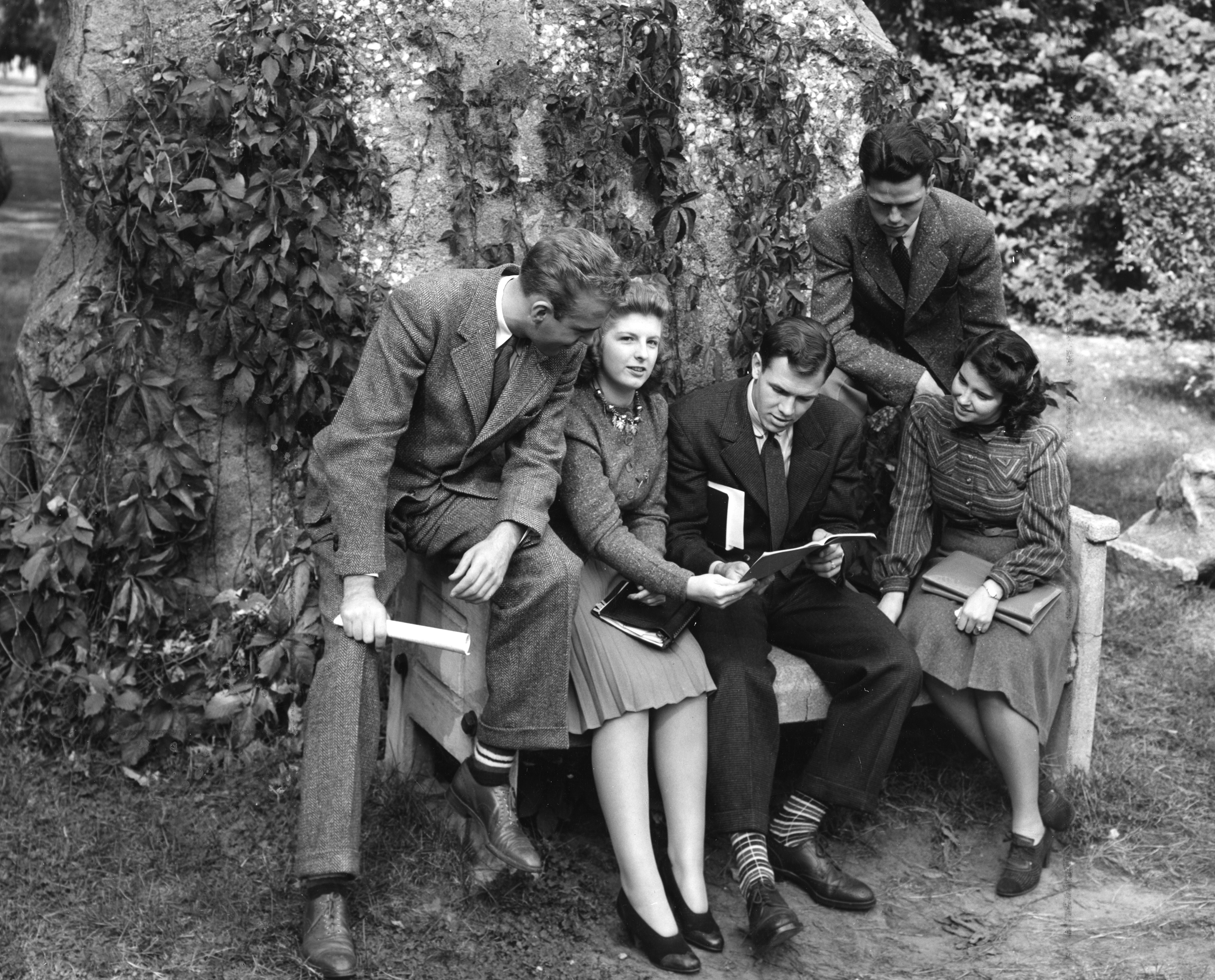 Group of students sitting in front of the Rock, ca. 1940s