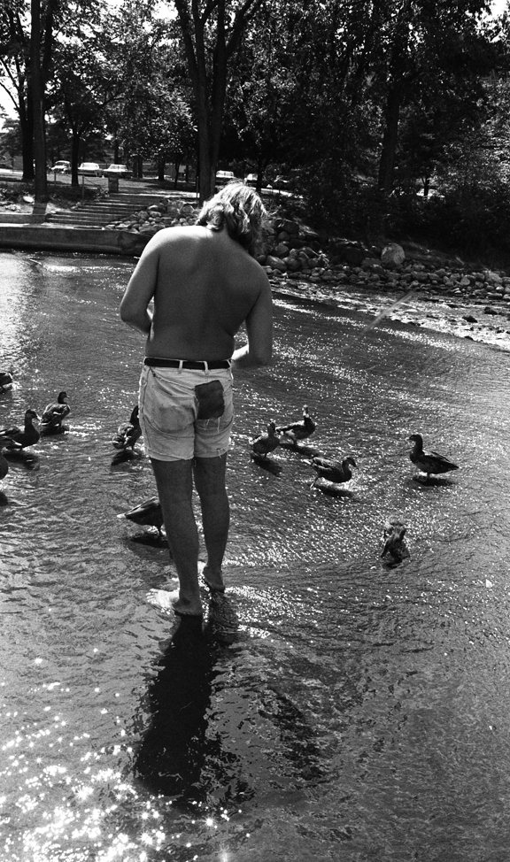 Students feeding ducks behind the Administration Building