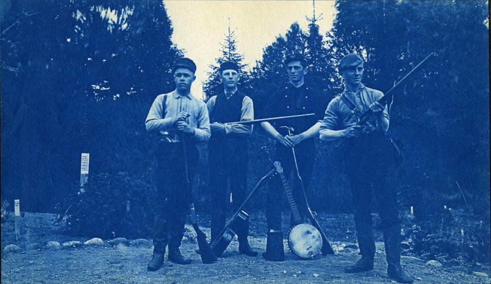 28. Men posing with rifles, a banjo and guitar, circa 1888.