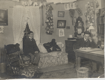 Two male students in their dorm room at Old Wells Hall, 1900