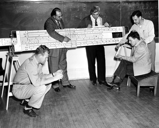 Students use a large slide rule, 1941