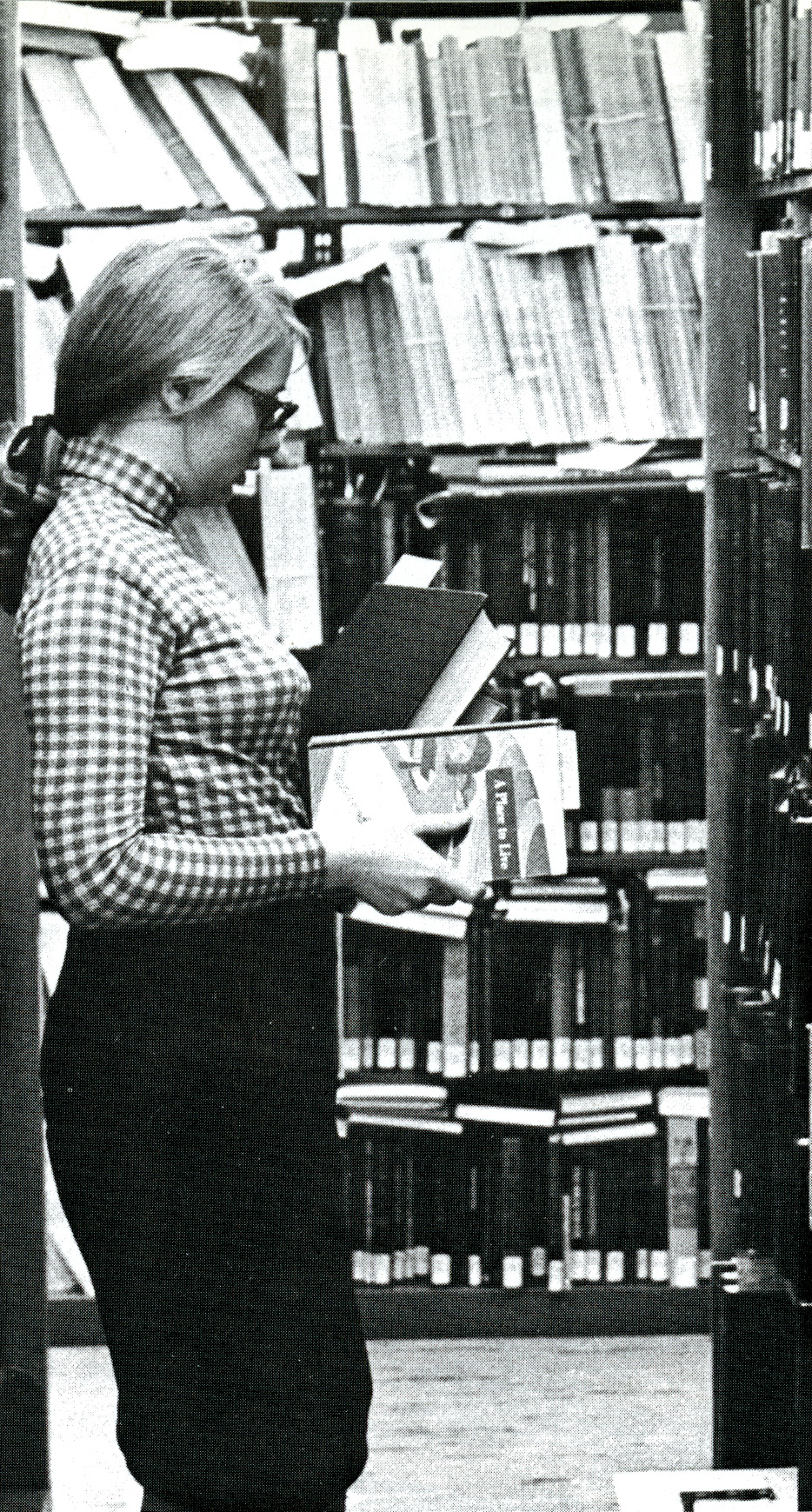 Woman looks for books in the library