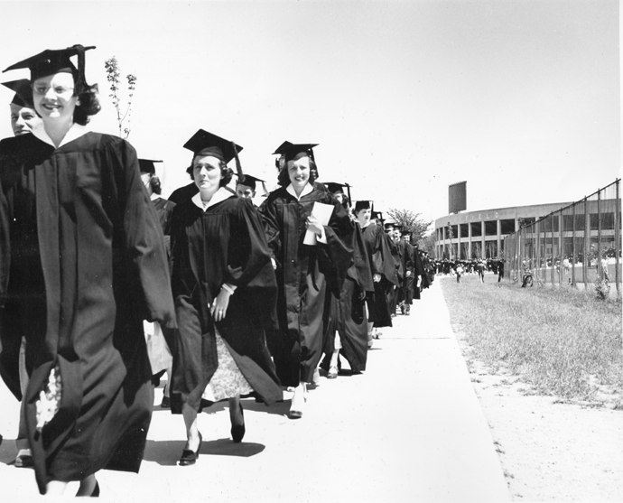 Students walk in a procession away from the Stadium, circa 1948-1950