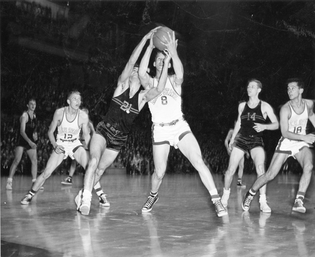 Basketball players fight for the ball, ca. 1950-1951 
