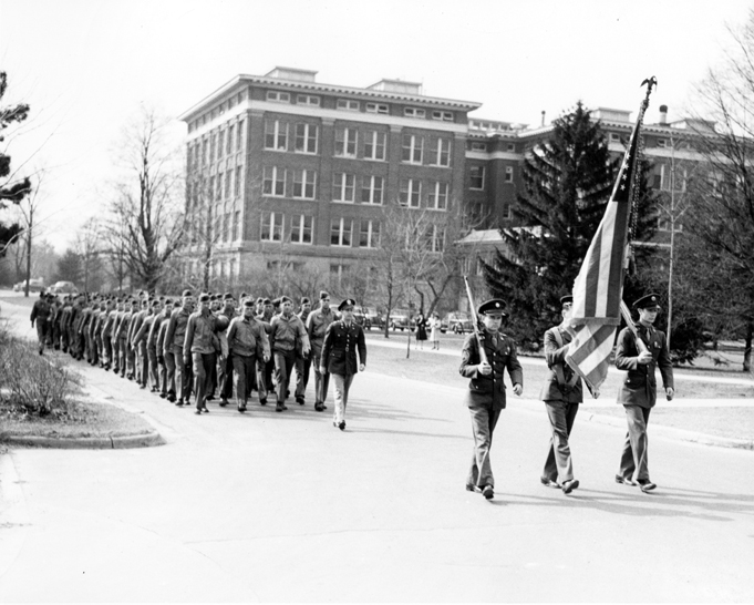 Soldiers march through campus, ca. 1940