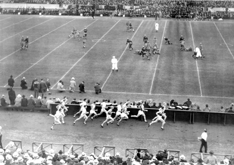 A football game takes place behind a foot race, 1934