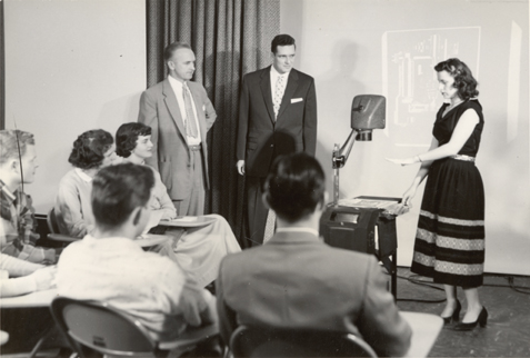 Woman giving presentation, date unknown