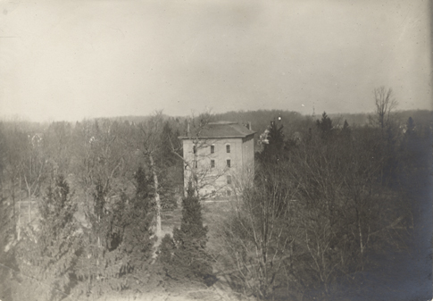 College Hall surrounded by trees, date unknown
