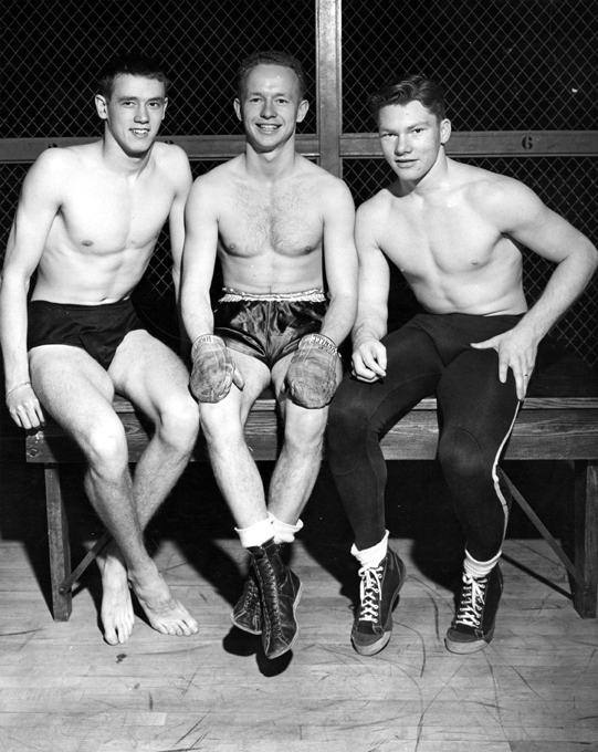 Boxer Chuck Davey sits with two other athletes, 1940 ca.