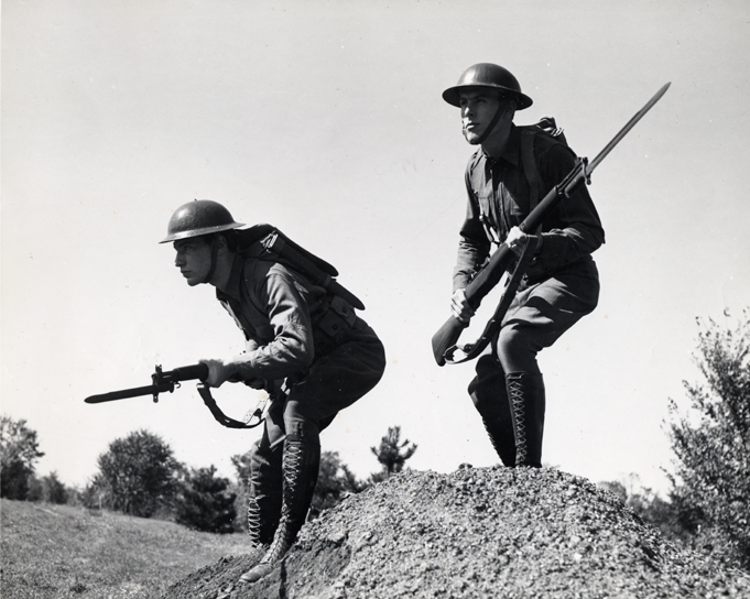 Two soldiers stand poised, ca. 1920