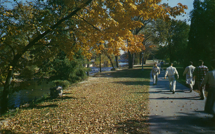 Students walking along the Red Cedar, date unknown