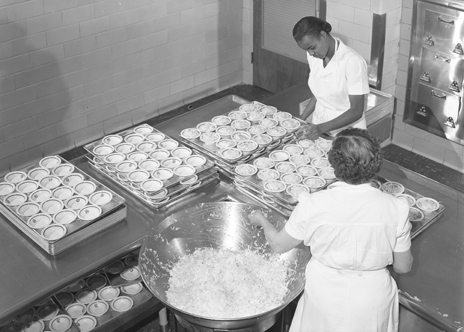 Plating food in the Brody Hall kitchen, 1954