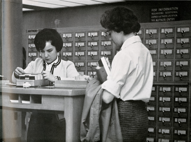 Two coeds checking the library card file