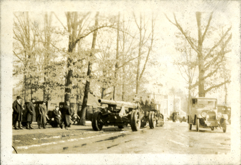 Street with tank and men, photographed by Onn Mann Liang, circa 1925