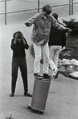 Student balancing on trashcan, 1966-1967