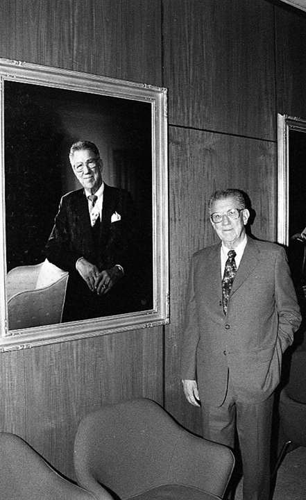 Edgar Harden standing next to his portrait, 1989