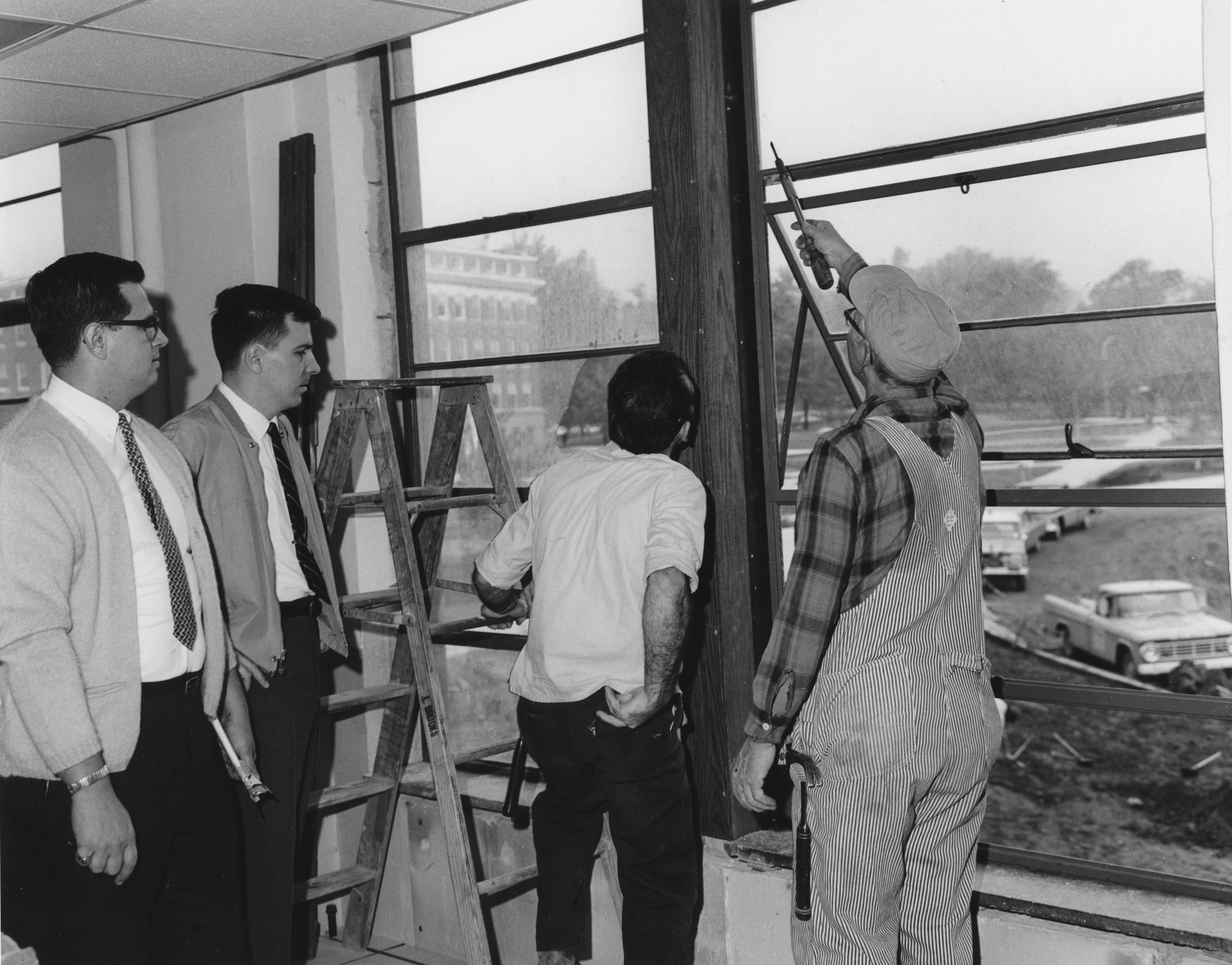 Workmen inspect a window in the Computer Center, date unknown