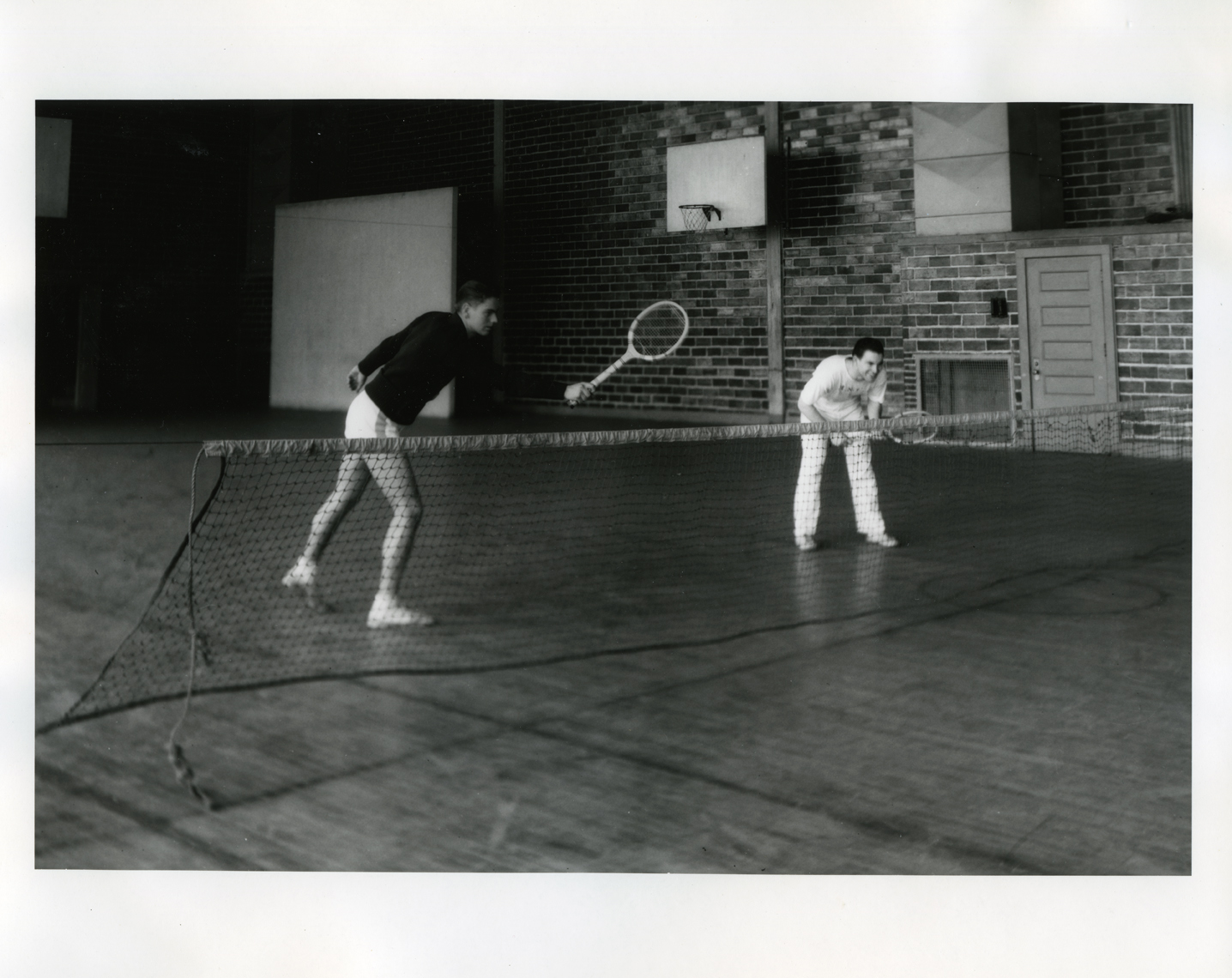 Men playing tennis, March 1936