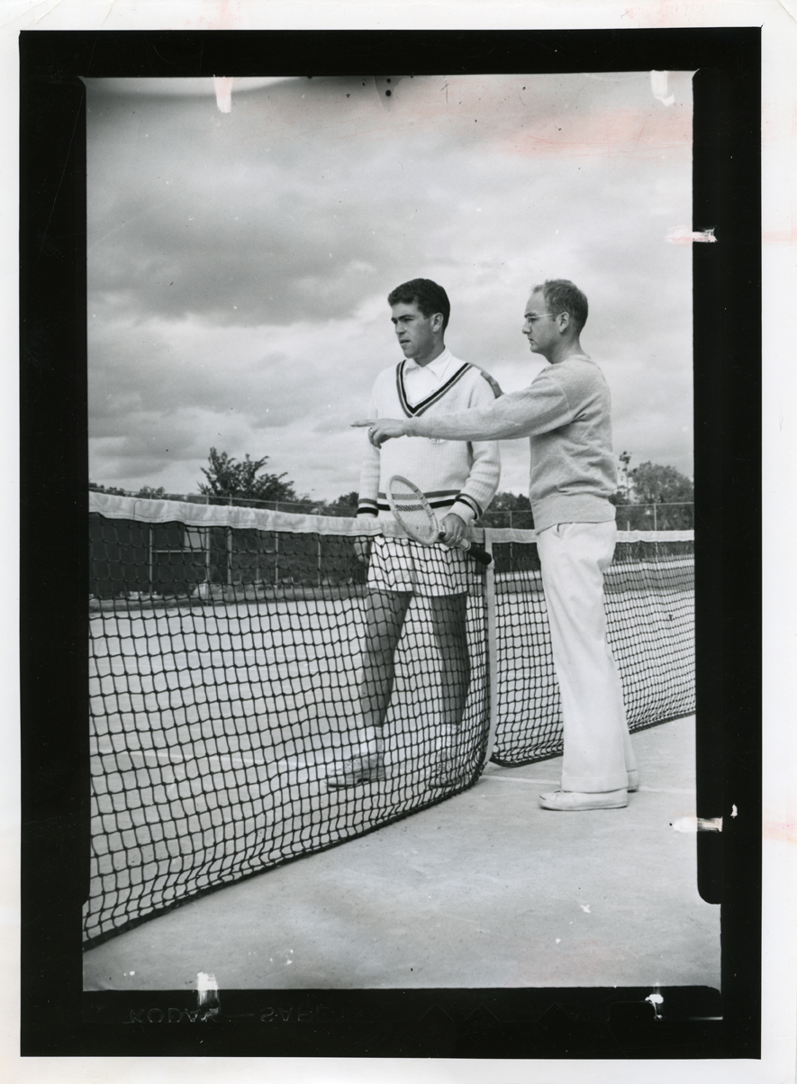 Tennis coach talks to player, circa 1949-1950