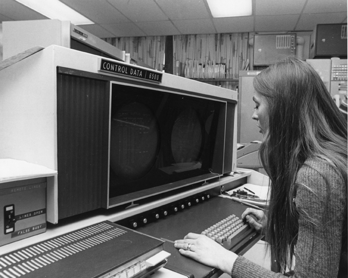 A woman uses the Control Data 6500 computer