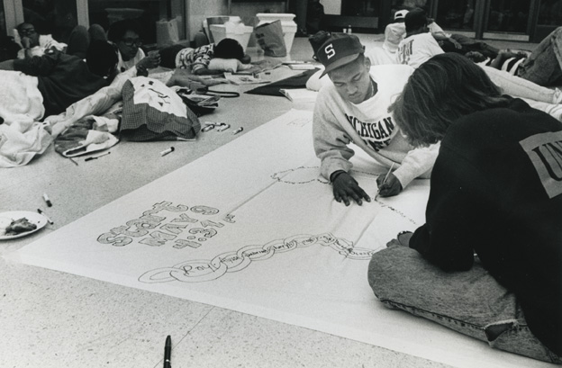 Two students making a protest banner during the 1989 student occupation of the Hannah Building