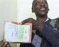 Isaac Malome Masike, a semi-retired small business man from Rammolutsi, shows his old pass book during an oral history interview with Dale McKinley and Ahmed Veriava. 