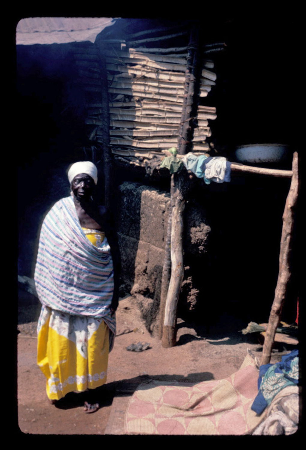 Old woman standing in village house, grandmother of Aggie