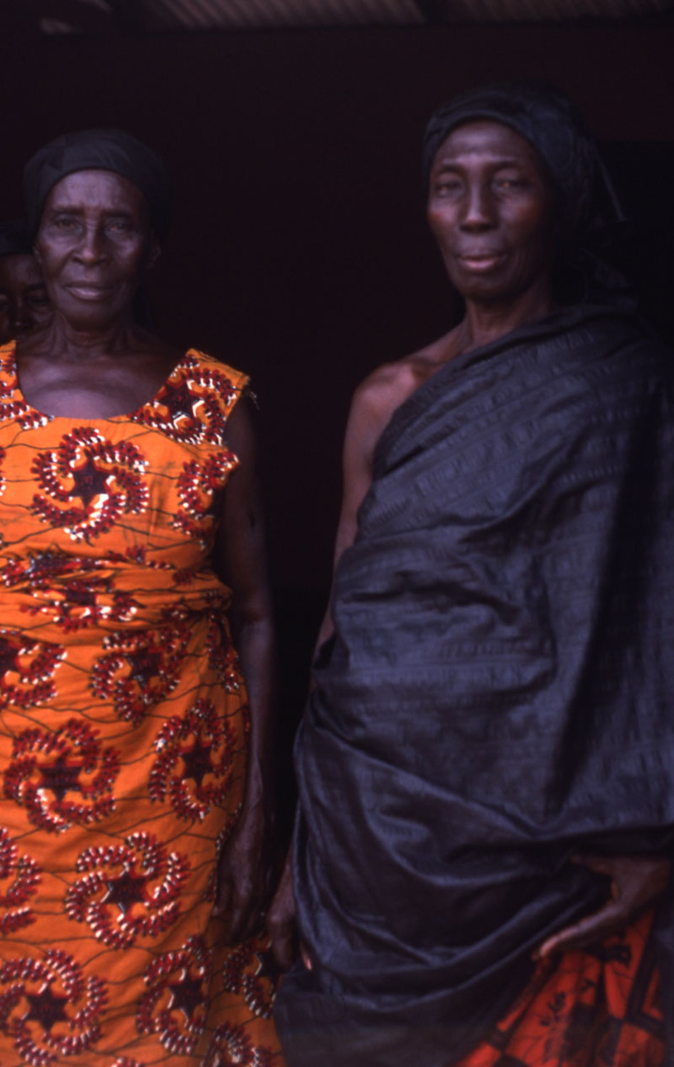 Two older women standing in funeral cloth