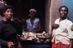 Three standing women in fish stall