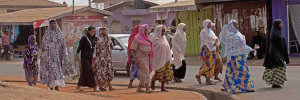 A group of women passing by in a Muslim neighborhood.