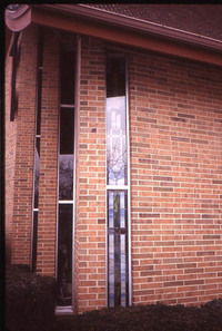 Left two windows were intended to be replaced with stained glass as of 1996.